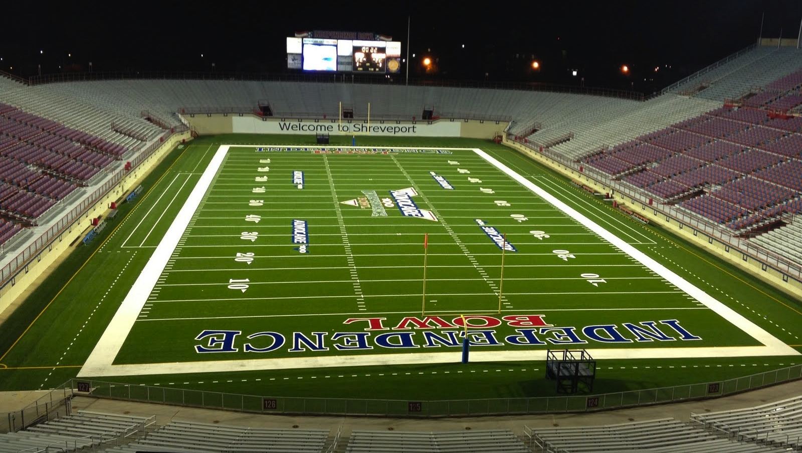 Independence Stadium in Shreveport lit up at night, with “Welcome to Shreveport” on the end-zone wall